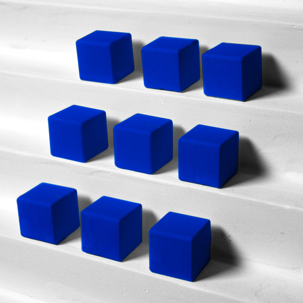 Blue cubes arranged in a pattern on a white surface