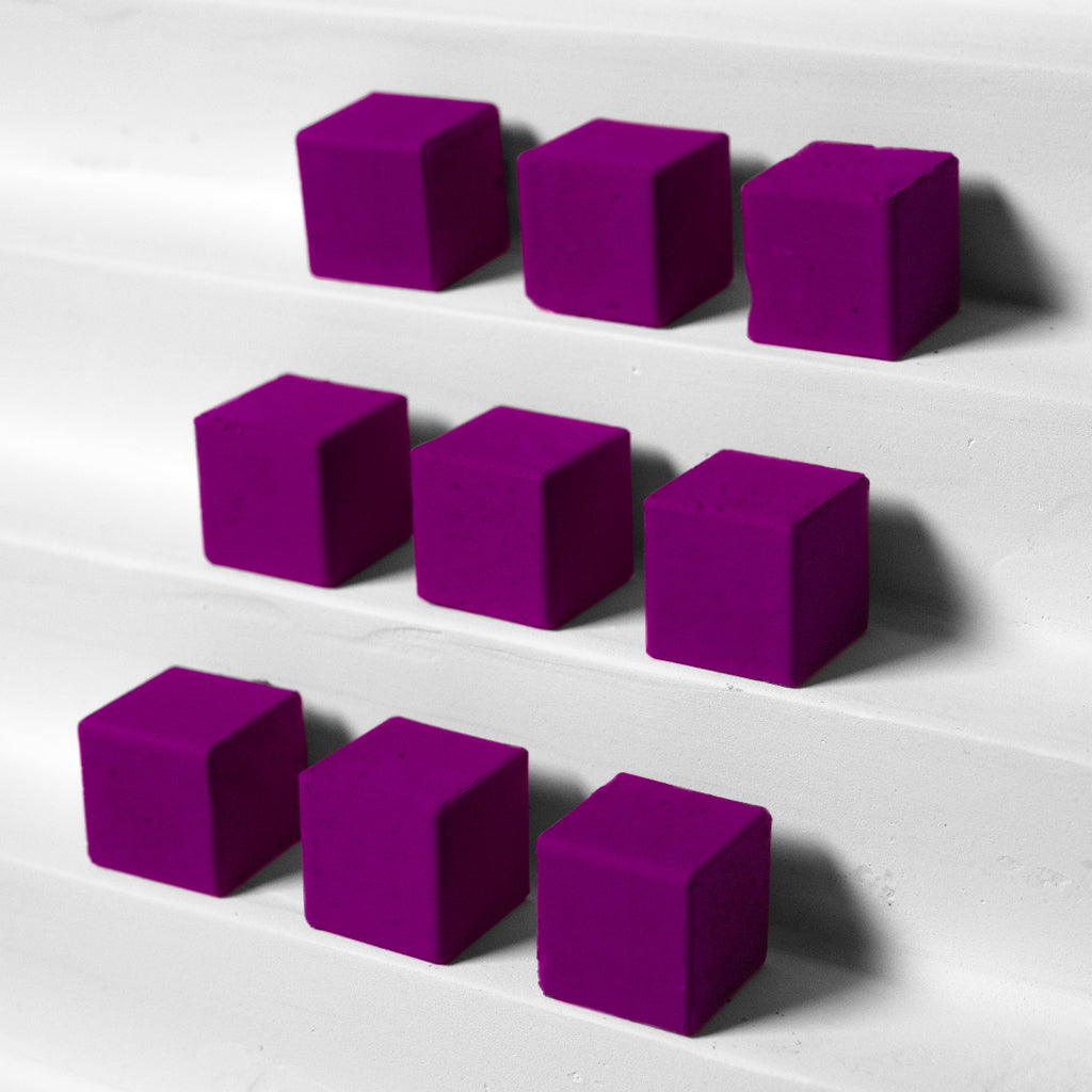 Purple cubes arranged in a pattern on a white surface