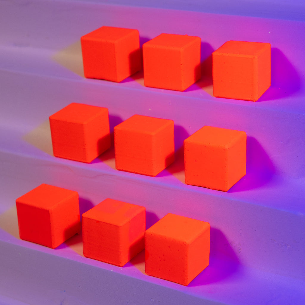 Red cubes on a purple and pink gradient background