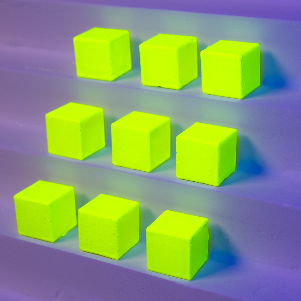 Nine bright yellow-green cubes on a mattepurple surface (NERPA)
